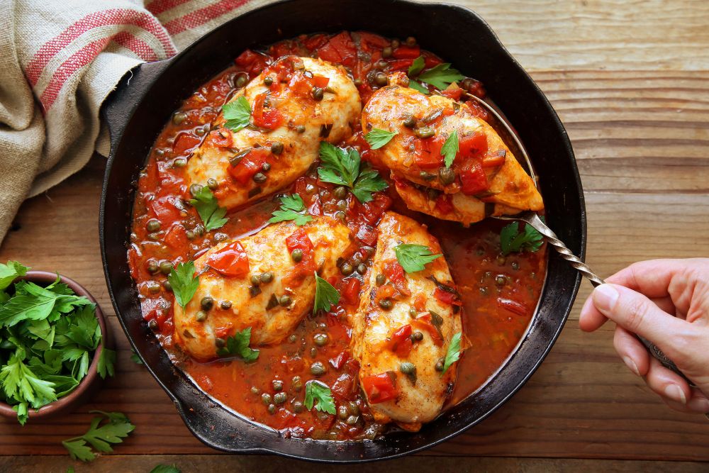 A plate of cooked chicken breasts