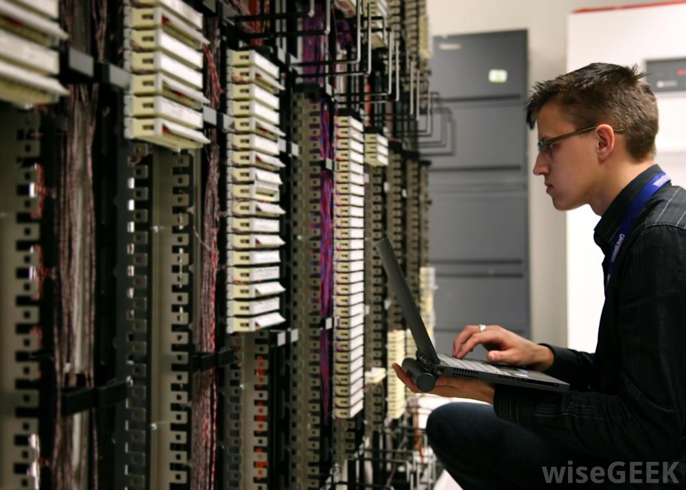 man-in-black-with-computer-near-server-31a92c39598bb5f108b736cc45d4696e.jpg