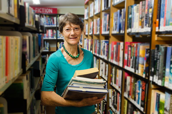 librarian-holding-books-depositphotoscom-lucidwaters-10852161-wd-0688a92ea5fd182883214fde084473a1.jpg