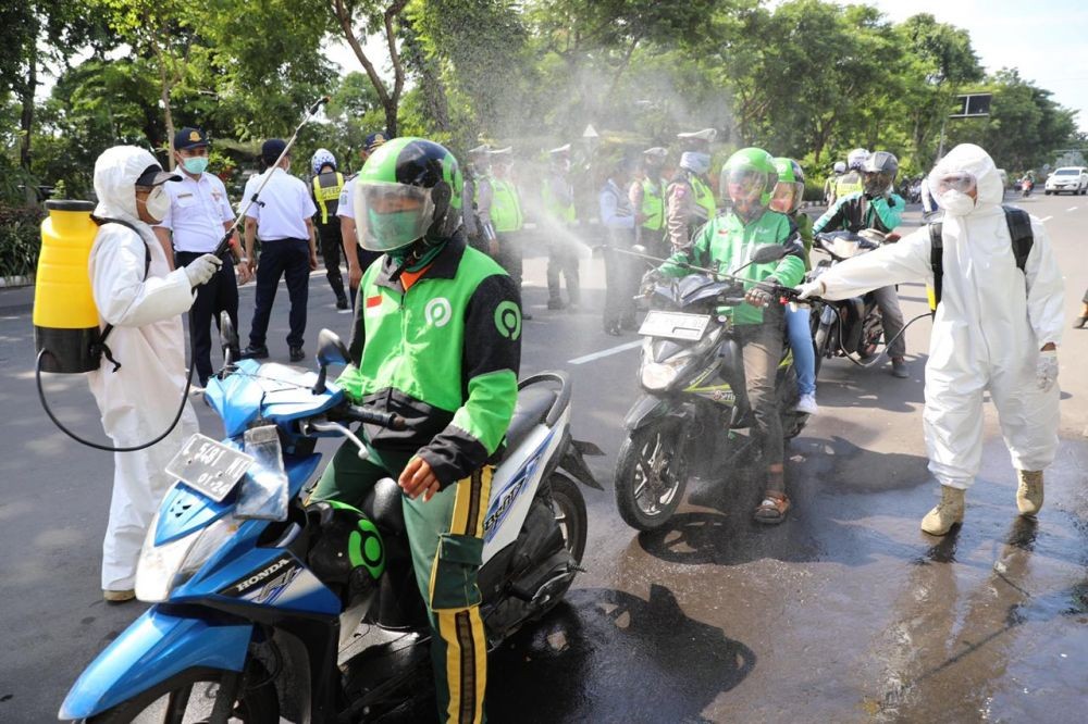 Virus Corona Merebak, Ratusan Ojol di Surabaya Disemprot Disinfektan 