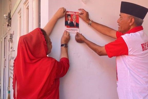 Mbak Ita Door to Door Tempel Stiker Capres Ganjar di Rumah Warga Semarang